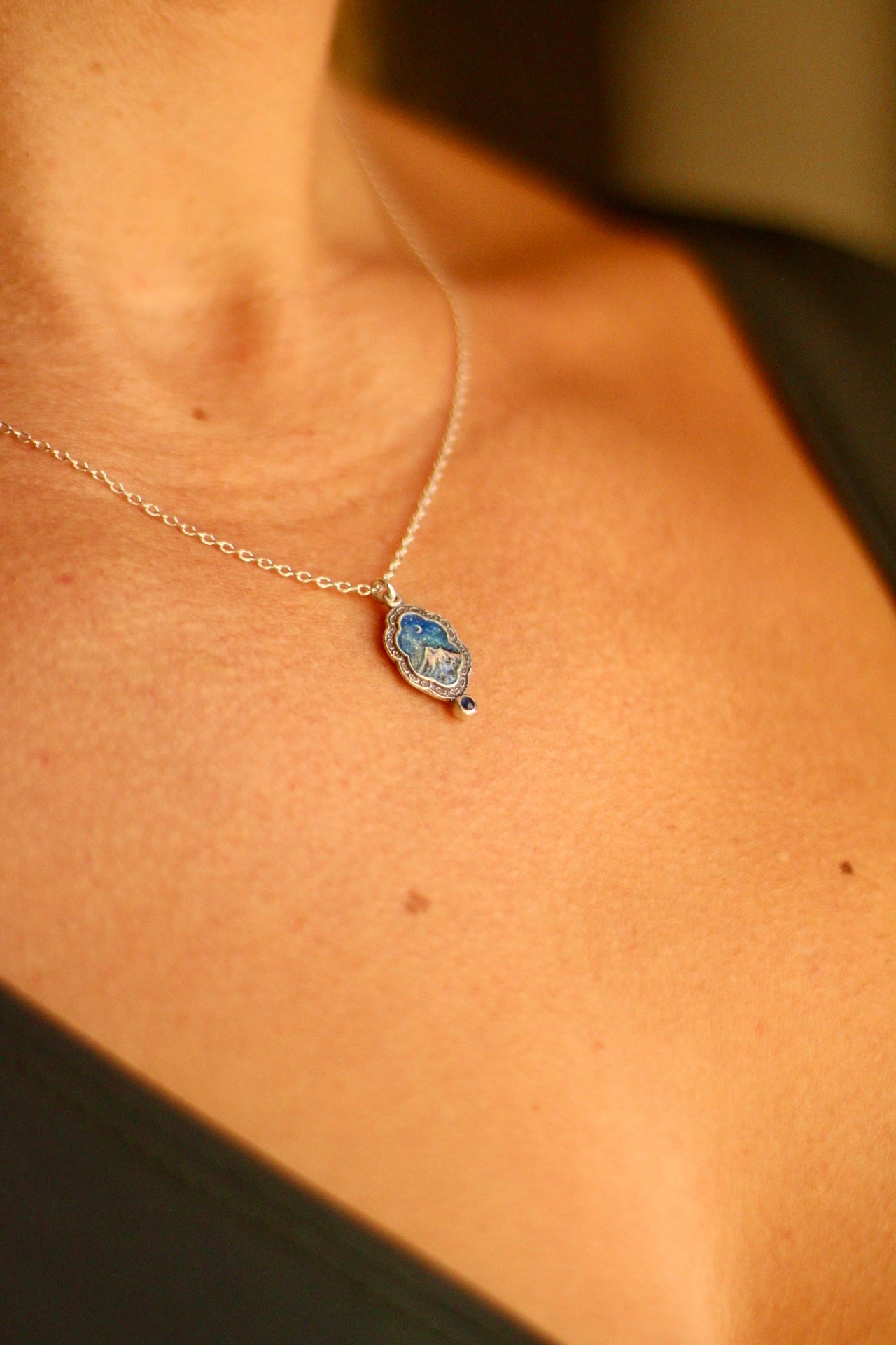 Silent snow falls on the mountain portal pendant