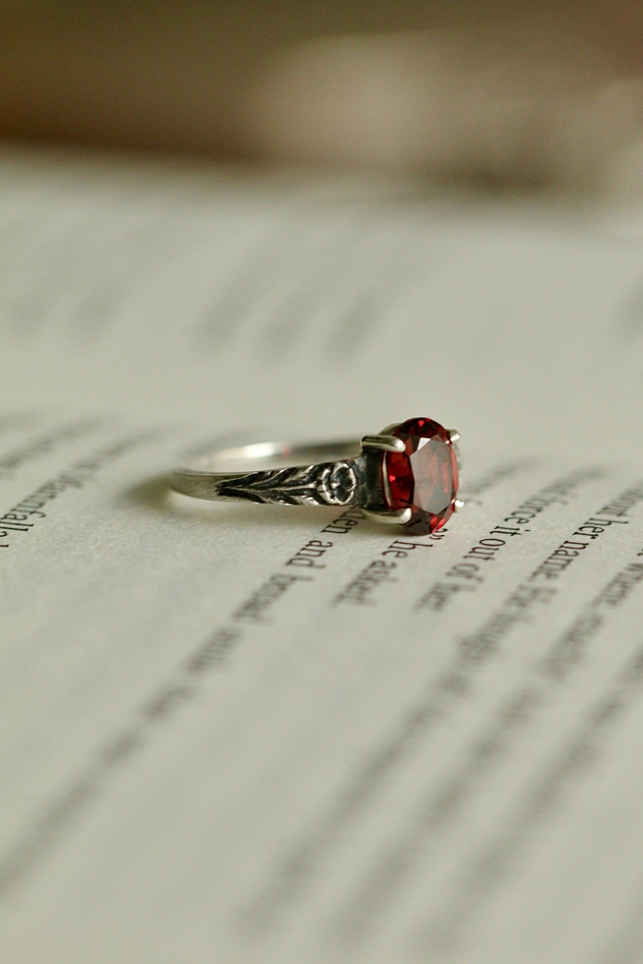 Silver poppy ring with prong set red garnet (preorder)