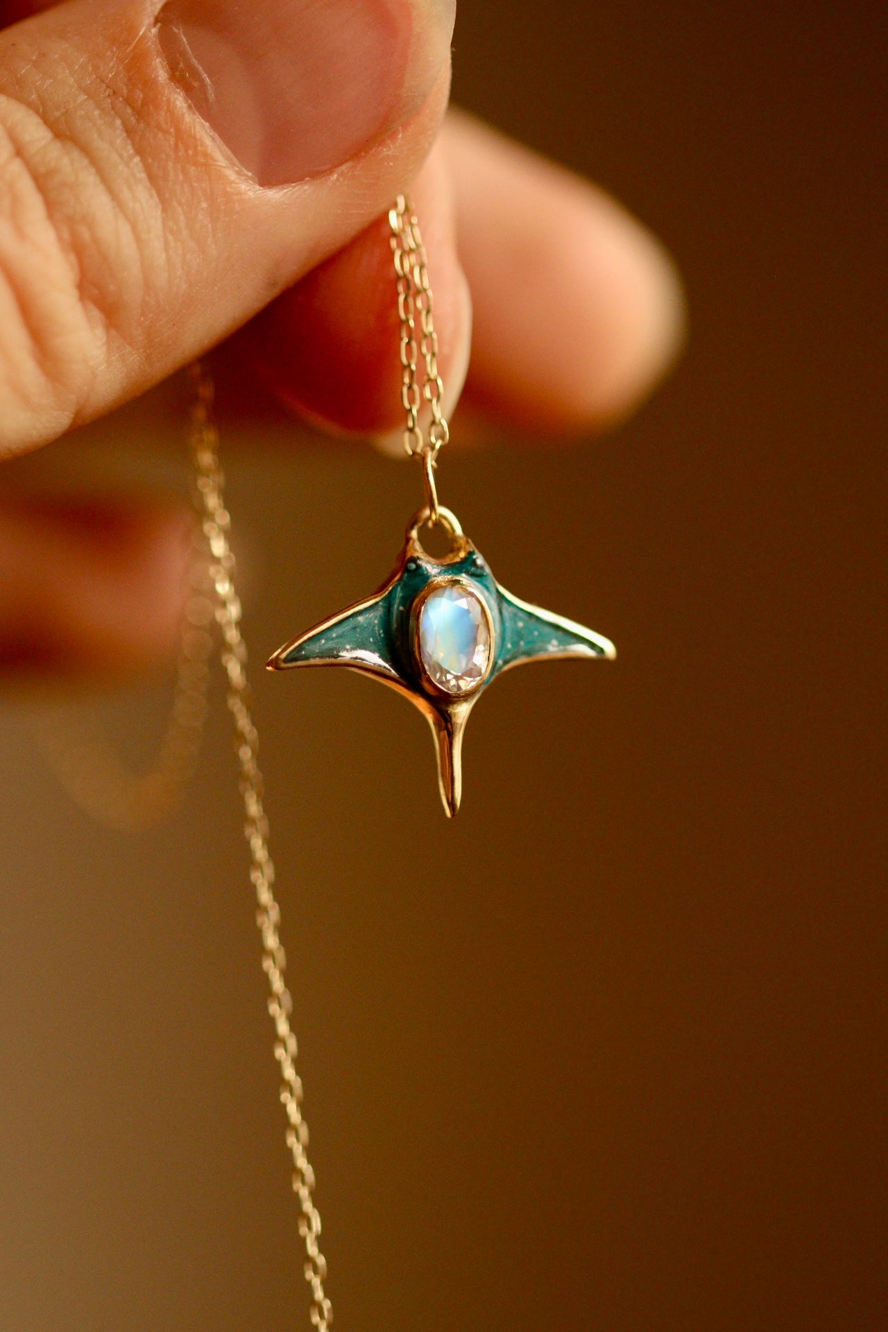 Solid 18k gold manta ray pendant with moonstone