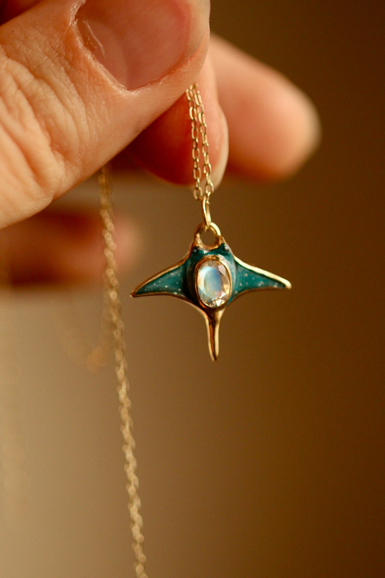 Solid 18k gold manta ray pendant with moonstone