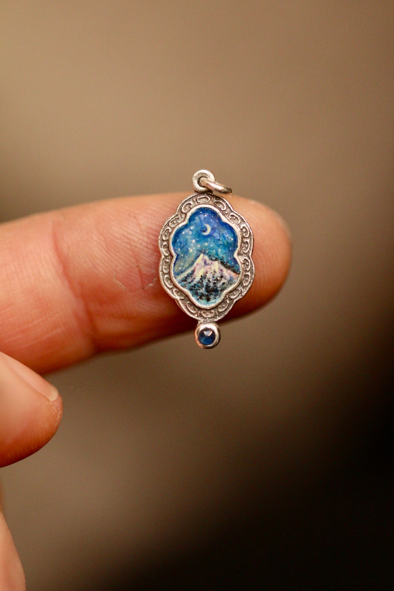 Silent snow falls on the mountain portal pendant