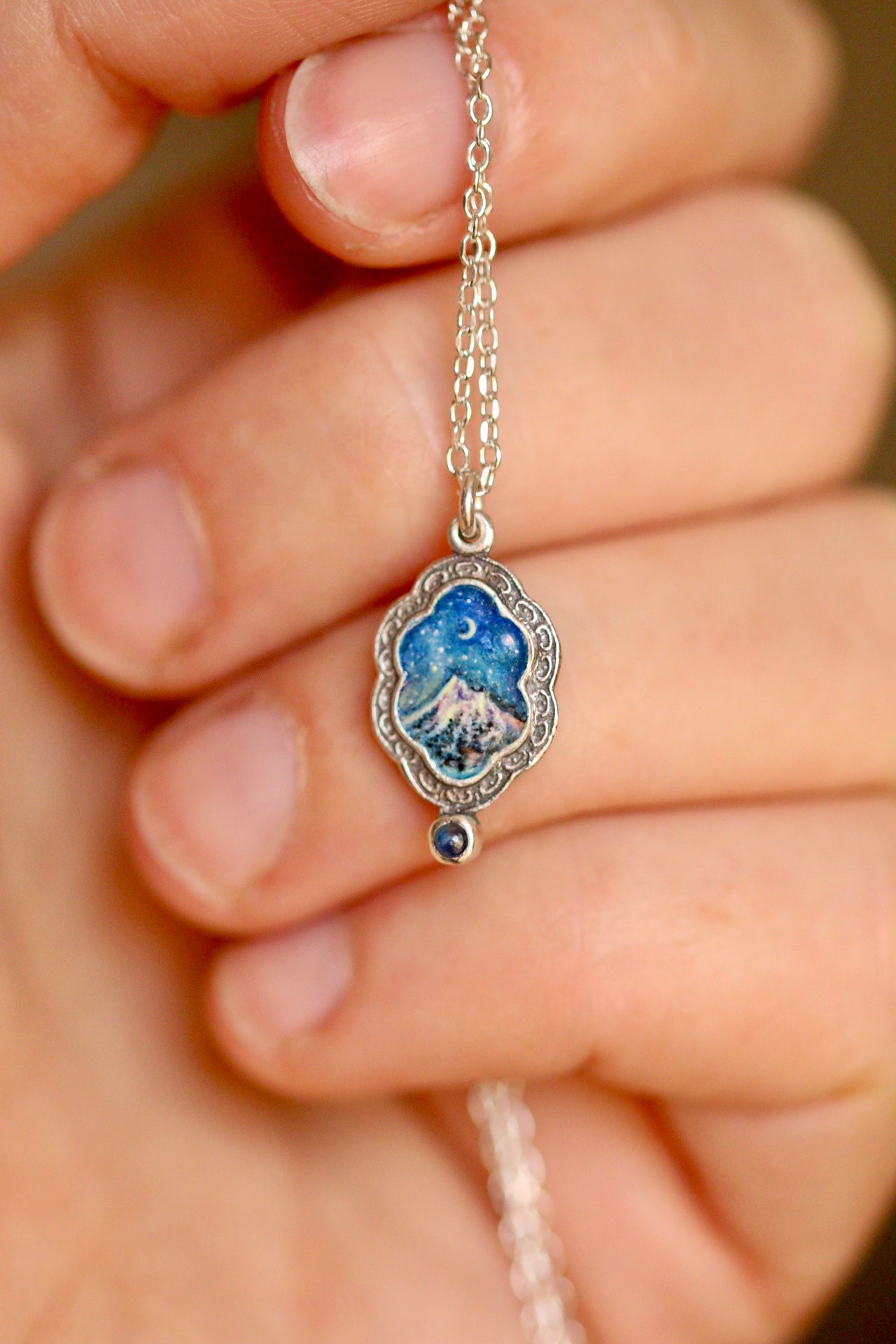 Silent snow falls on the mountain portal pendant