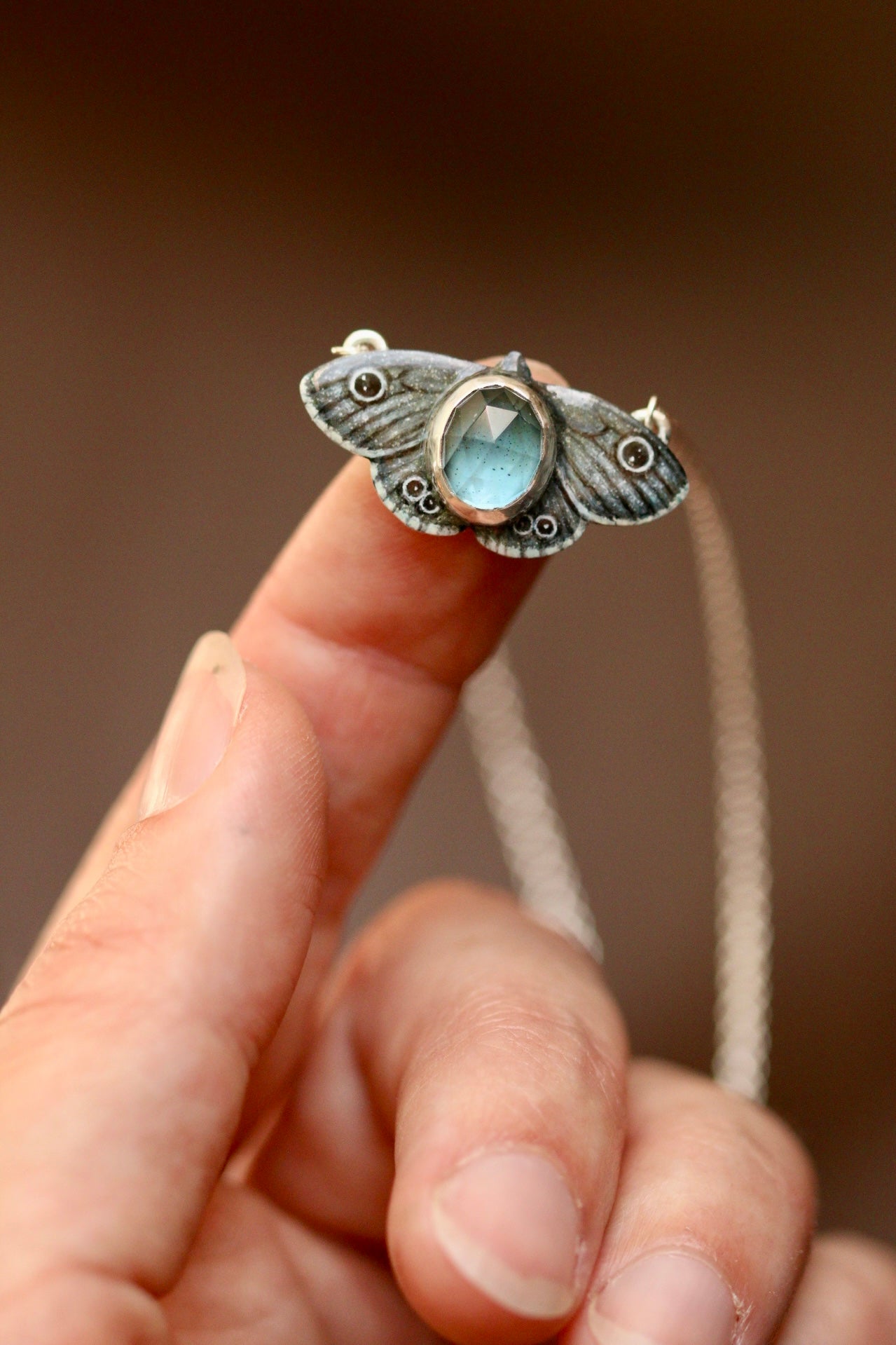 Common four ring butterfly pendant