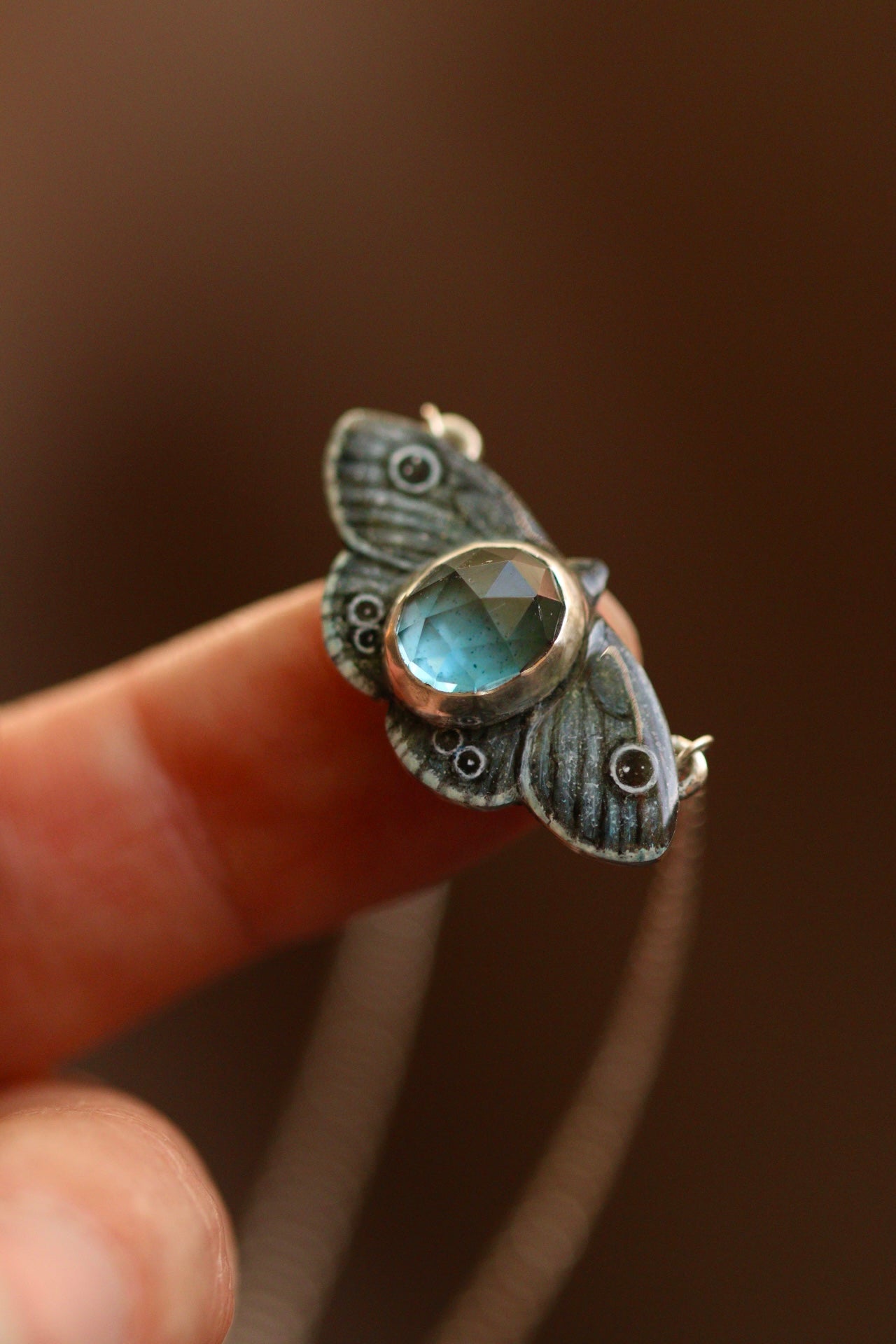Common four ring butterfly pendant