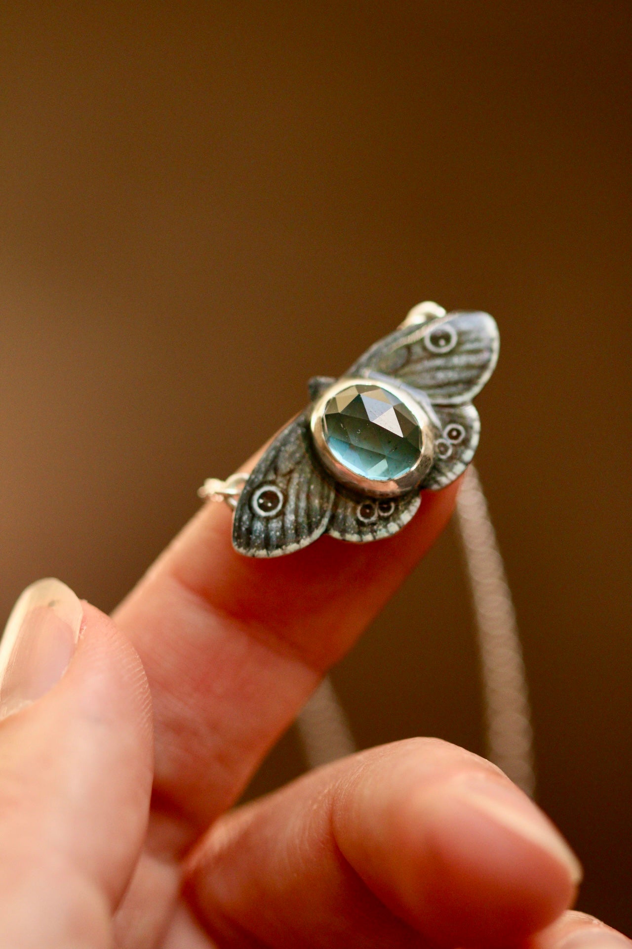 Common four ring butterfly pendant