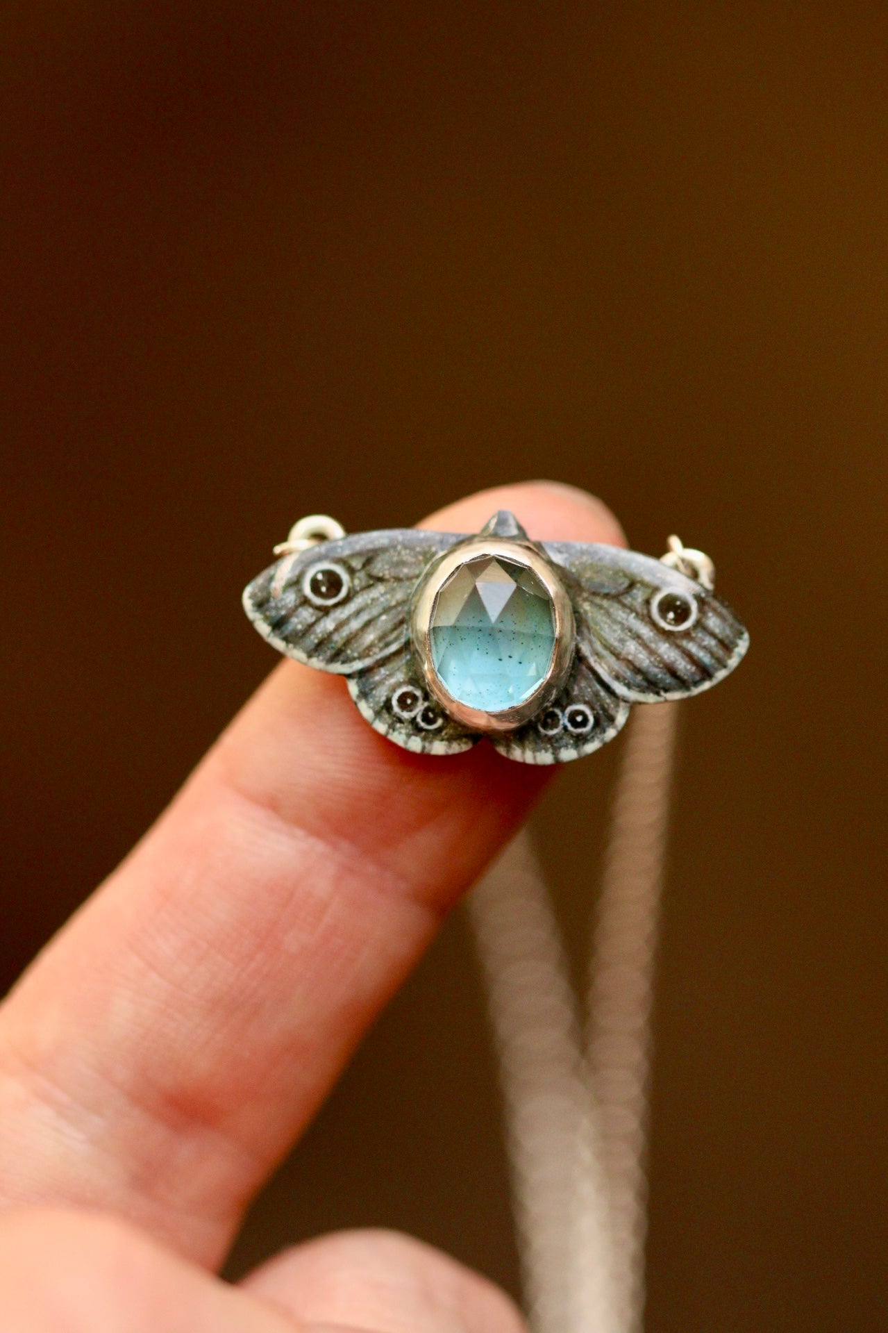 Common four ring butterfly pendant