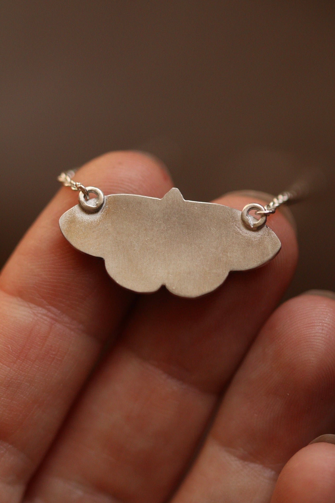 Common four ring butterfly pendant