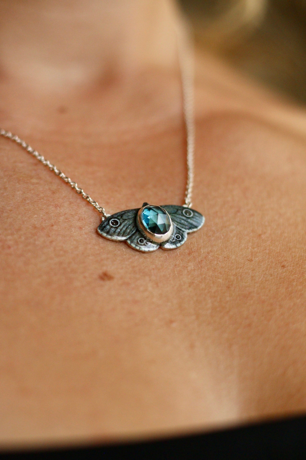 Common four ring butterfly pendant